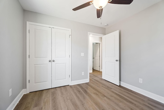 unfurnished bedroom with ceiling fan, light hardwood / wood-style flooring, and a closet