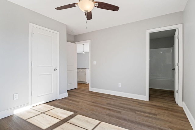 unfurnished bedroom with ceiling fan, a closet, and dark hardwood / wood-style floors