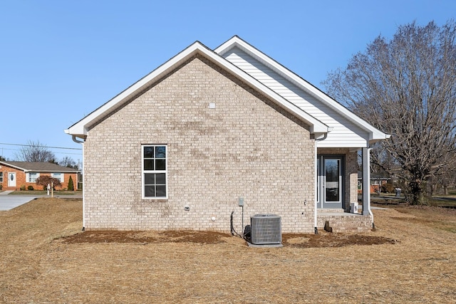 view of side of home with central AC