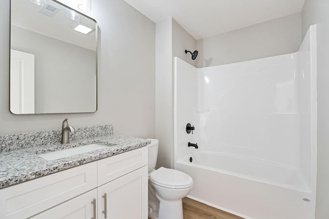 full bathroom with hardwood / wood-style flooring, vanity, toilet, and shower / bathing tub combination