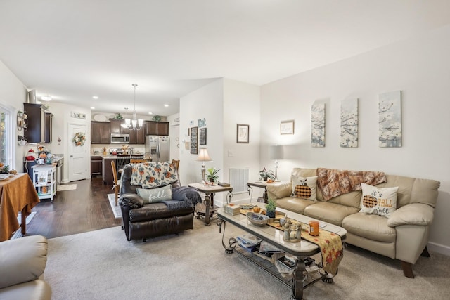 living room with a notable chandelier and dark wood-type flooring