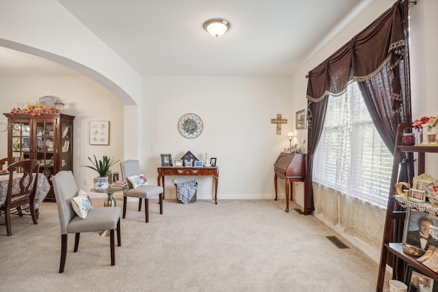 sitting room featuring light carpet