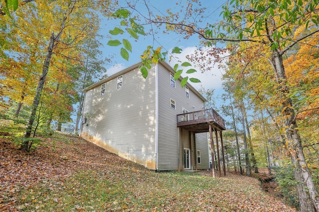 view of side of home with a wooden deck