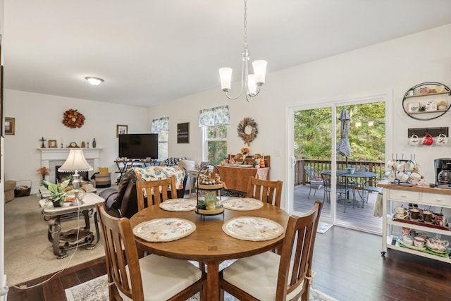 dining space featuring dark wood-type flooring and an inviting chandelier