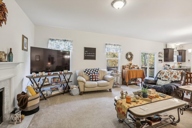 living room with light colored carpet and a fireplace