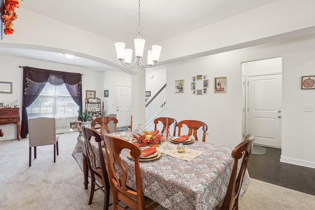 dining room featuring a chandelier and carpet