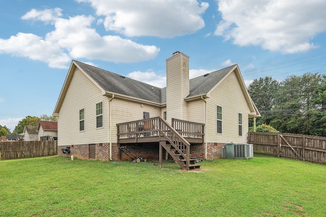 rear view of house with a yard, a deck, and central AC unit