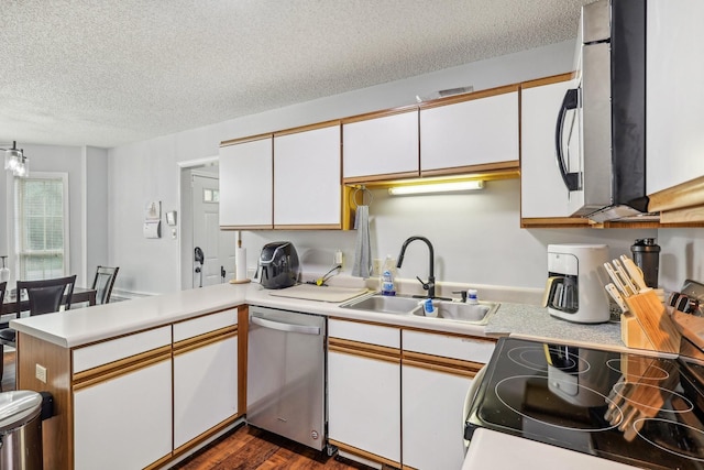 kitchen with white cabinets, sink, stainless steel dishwasher, a textured ceiling, and range