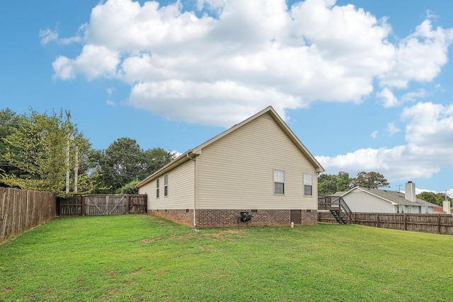 view of side of home featuring a yard