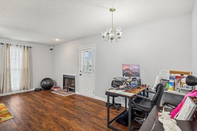 office featuring dark hardwood / wood-style floors, a textured ceiling, and an inviting chandelier