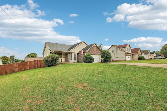 single story home with a front yard, a porch, and a garage