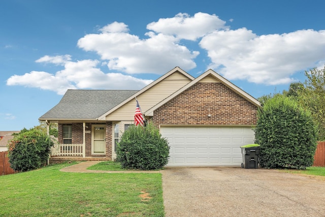 view of front facade with covered porch, a garage, and a front lawn