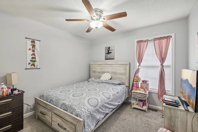 carpeted bedroom with ceiling fan and a textured ceiling