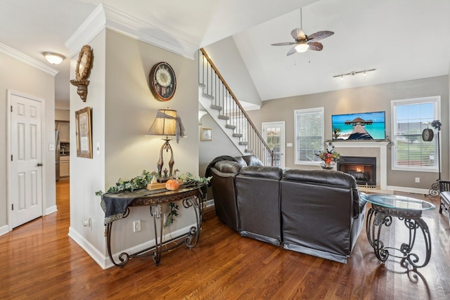 living room featuring ceiling fan, hardwood / wood-style floors, vaulted ceiling, and crown molding