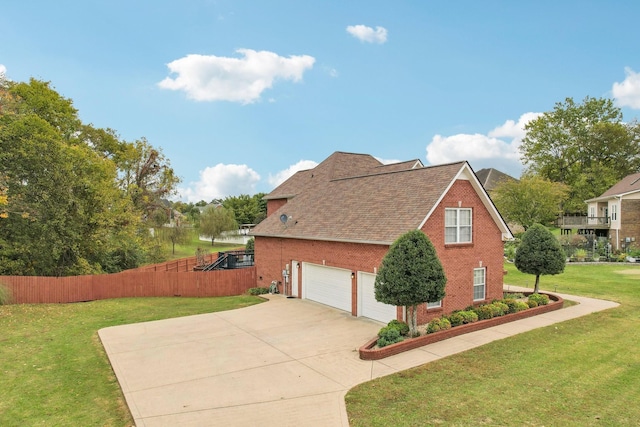 view of side of property featuring a lawn and a garage