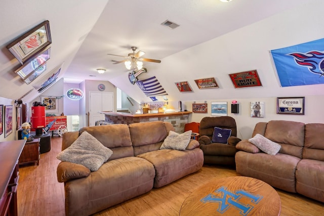 living room featuring vaulted ceiling, ceiling fan, and hardwood / wood-style flooring