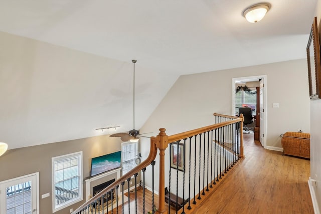 hall featuring vaulted ceiling and light hardwood / wood-style flooring