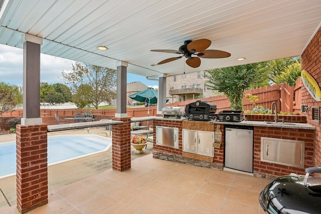 view of patio with sink, grilling area, area for grilling, and ceiling fan