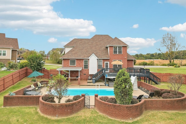 view of pool with a deck, a yard, and a fire pit