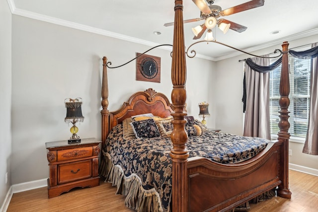 bedroom featuring light hardwood / wood-style flooring, ceiling fan, crown molding, and multiple windows