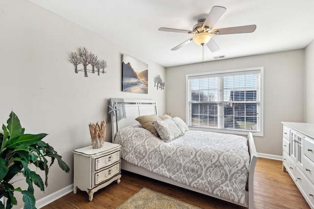 bedroom with ceiling fan and dark hardwood / wood-style floors