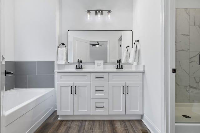 bathroom with hardwood / wood-style floors, vanity, separate shower and tub, and ceiling fan