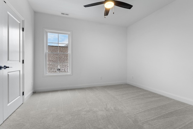 empty room featuring light carpet and ceiling fan