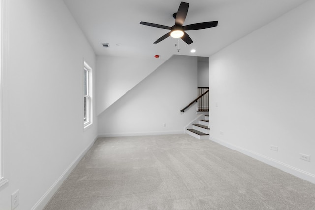 unfurnished living room featuring ceiling fan and light colored carpet