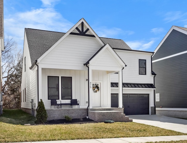 modern farmhouse with a front yard, a porch, concrete driveway, and an attached garage