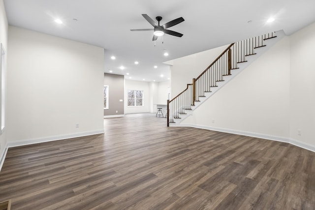 unfurnished living room with ceiling fan and dark hardwood / wood-style flooring