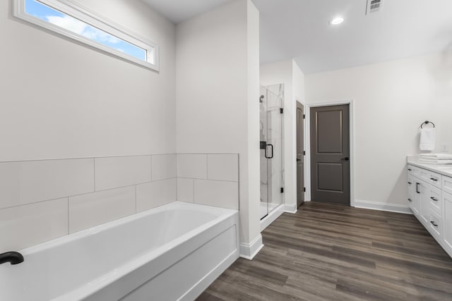 bathroom with shower with separate bathtub, vanity, and wood-type flooring