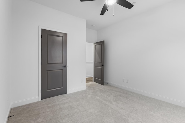 unfurnished bedroom with ceiling fan and light carpet