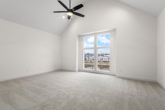 empty room with ceiling fan, light carpet, and high vaulted ceiling