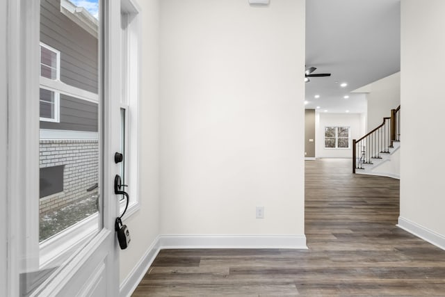 entryway featuring ceiling fan and dark wood-type flooring