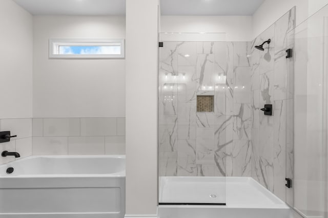 bathroom featuring separate shower and tub