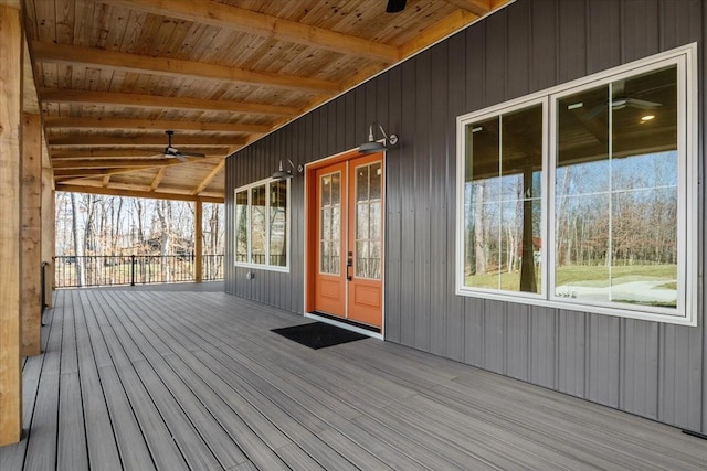 wooden deck with ceiling fan and french doors