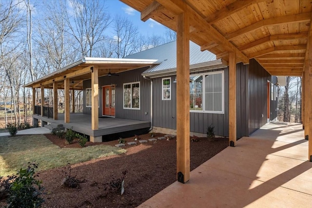 exterior space with ceiling fan, metal roof, and board and batten siding