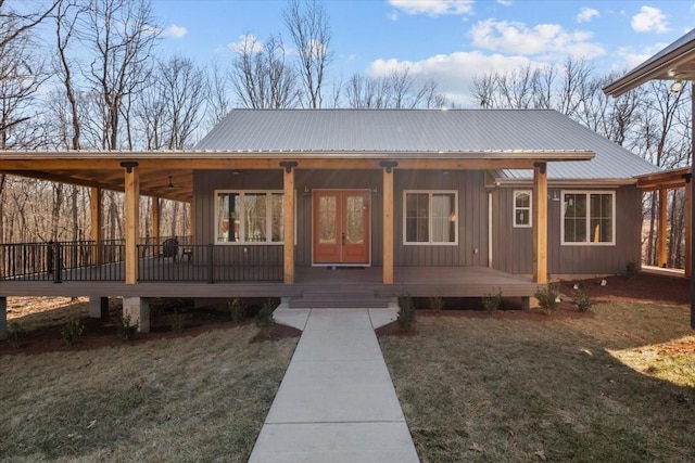 exterior space featuring a porch, metal roof, and a yard