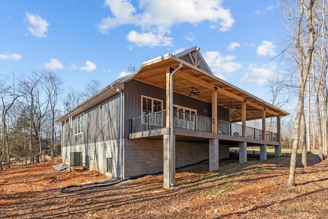 view of side of home with ceiling fan and central AC