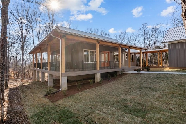 view of property exterior featuring covered porch and a yard