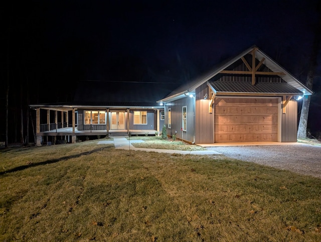 view of front of home featuring a garage, a porch, and a lawn