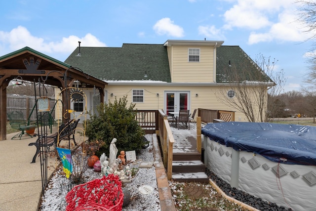 rear view of house featuring a swimming pool side deck and a gazebo