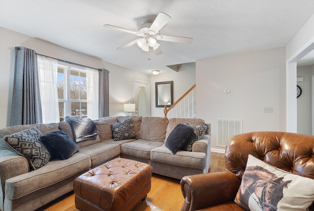 living room with ceiling fan and light hardwood / wood-style floors