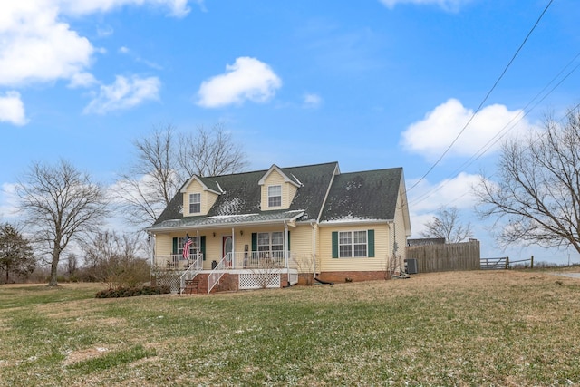 cape cod home featuring a porch and a front yard