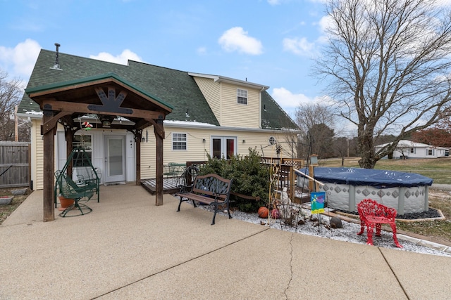 back of house featuring a patio area, french doors, and a covered pool