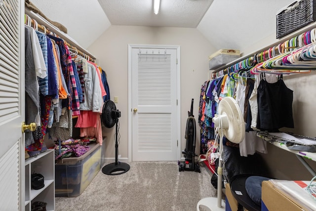 spacious closet with carpet and vaulted ceiling