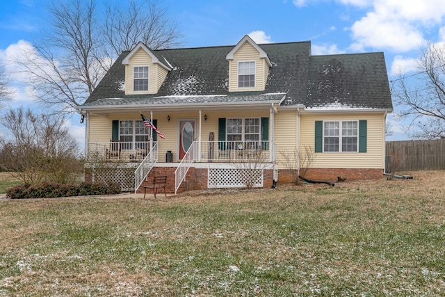 cape cod house featuring covered porch and a front yard