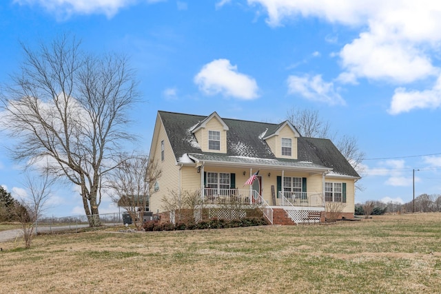 cape cod-style house with covered porch and a front yard