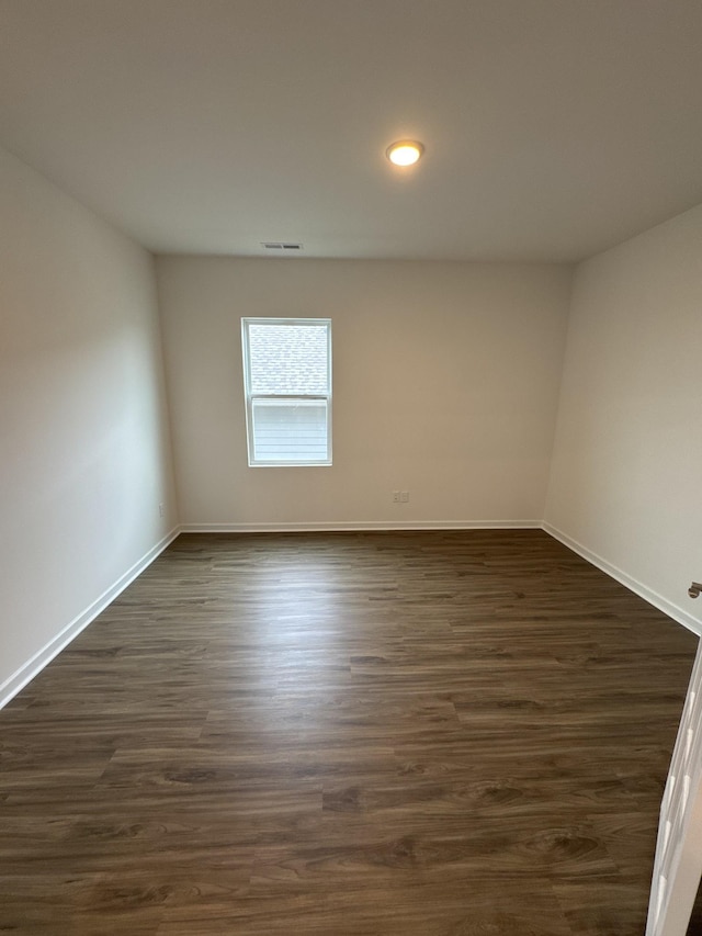 unfurnished room featuring dark hardwood / wood-style floors