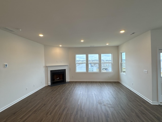 unfurnished living room with dark hardwood / wood-style floors